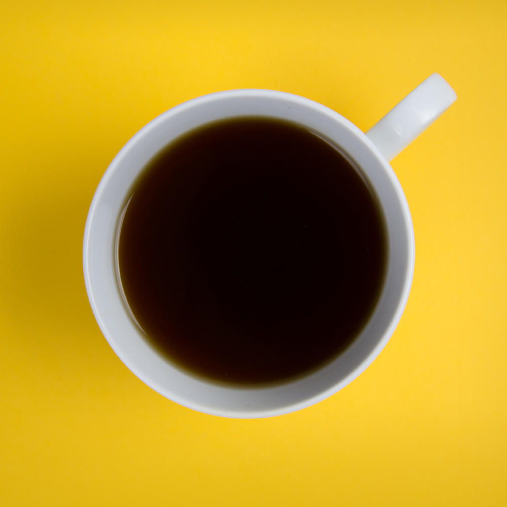 view from above of a coffee cup filled with black coffee